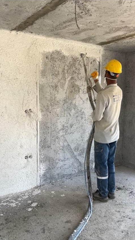 Perlite insulation plaster being applied to the interior face